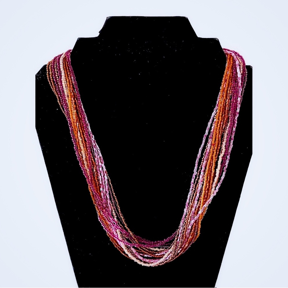 Multi strand seed bead necklace in lavender and amber tones.